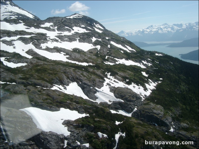 Views of the mountains, snow, icefields, etc. from inside the helicopter. Skagway.