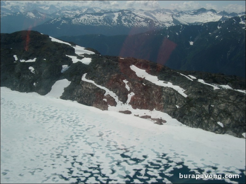 Views of the mountains, snow, icefields, etc. from inside the helicopter. Skagway.