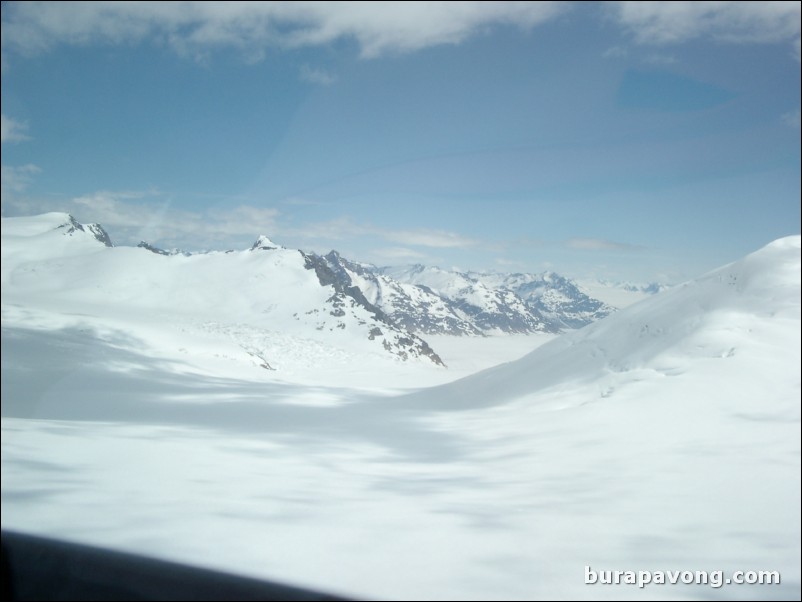 Views of the mountains, snow, icefields, etc. from inside the helicopter. Skagway.