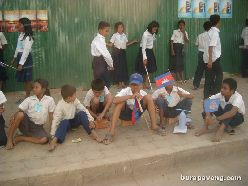 School children lining the streets to greet the king.