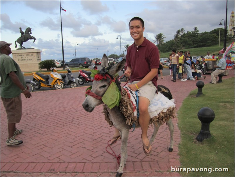 Riding donkey outside of fort.