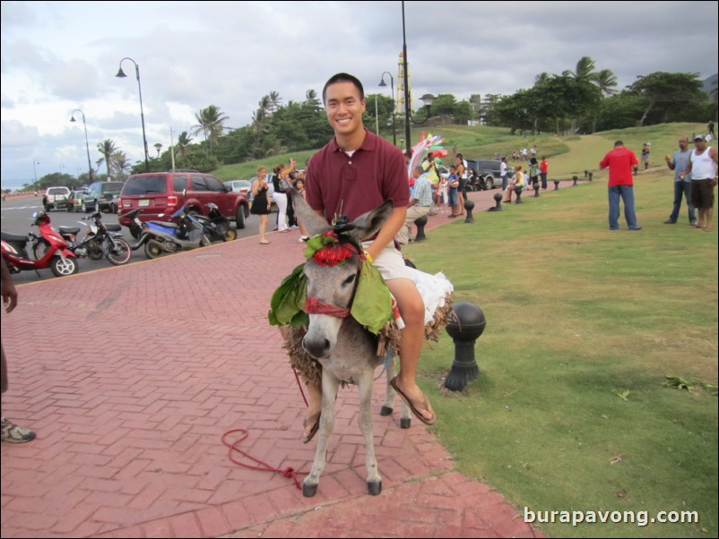 Riding donkey outside of fort.