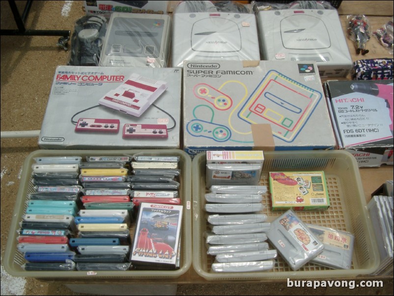 An old Nintendo Family Computer and Super Famicom with games at a flea market in Rinku Town.