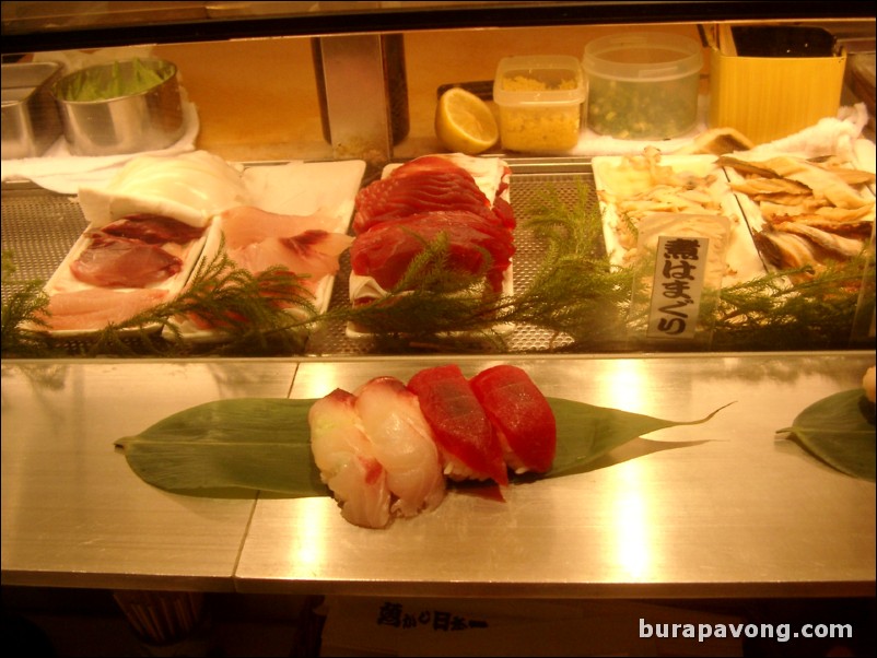 Some hamachi and meguro nigiri at a standing sushi bar, west Shinjuku.