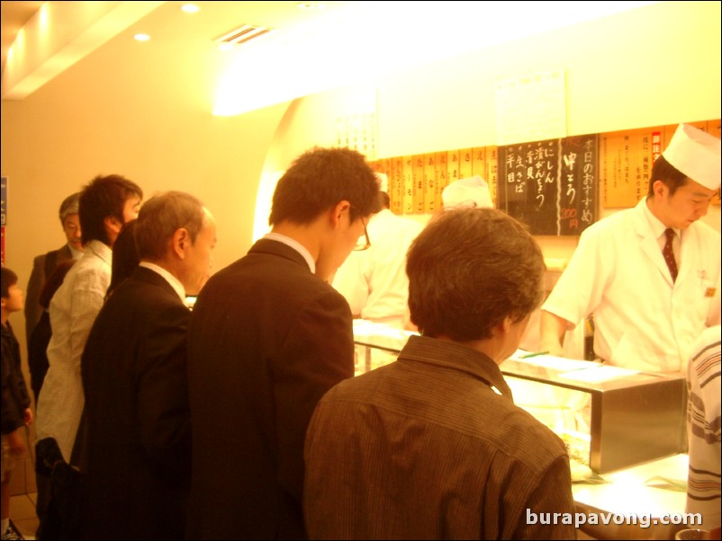 Packed standing sushi bar, west Shinjuku.