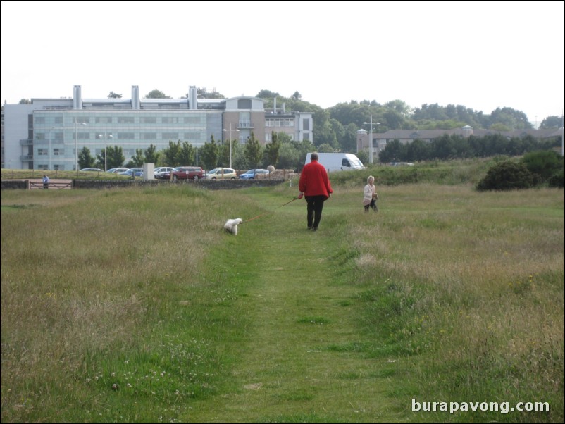 Man walking his dog on The Old Course.