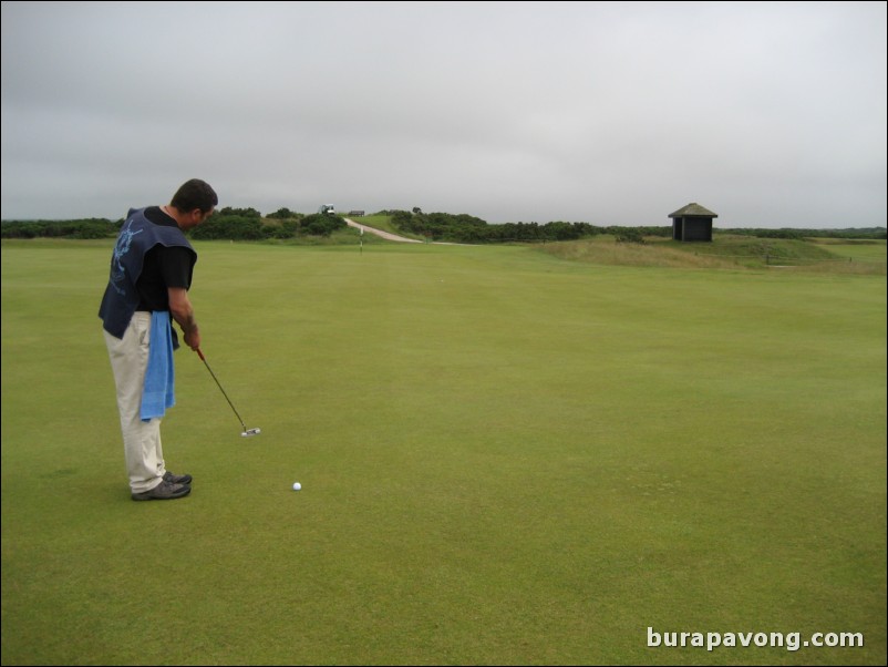 One of the caddies playing around on the No. 5 green.  This green is 100 yards long!