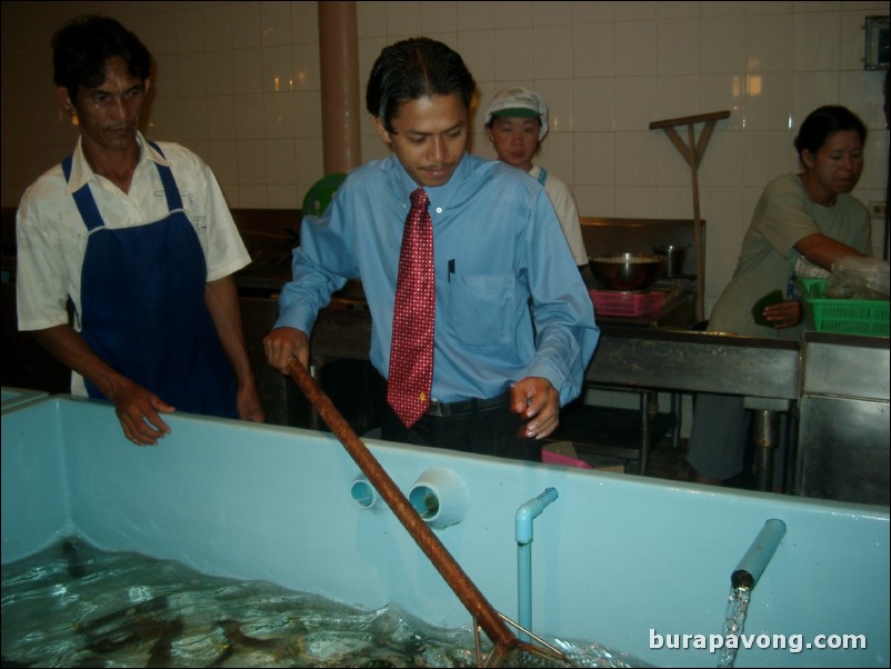 Manager of Kan Eng Restaurant catching our meals for us.