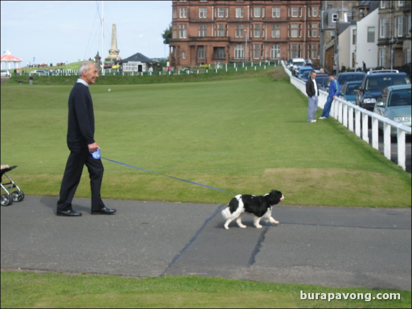 Sunday on The Old Course.  Man walking his dog on Granny Clark's Wynd.